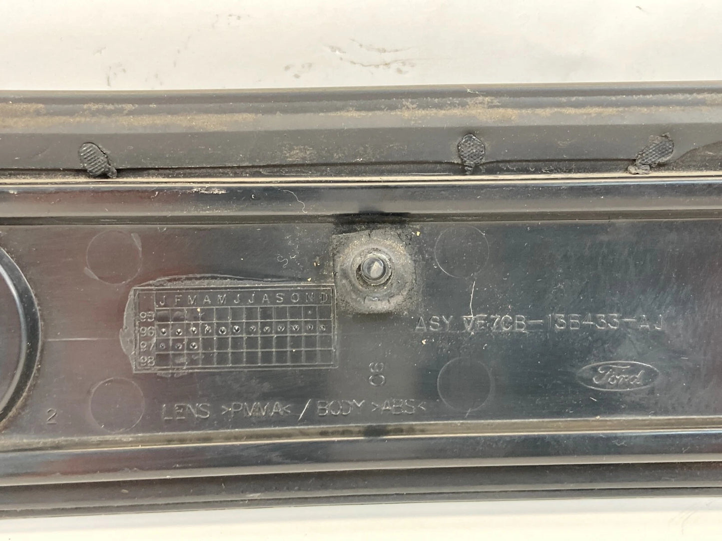 1997-2002 FORD ESCORT SEDAN REAR CENTER TRUNK LID TAIL LIGHT FINISH PANEL OEM