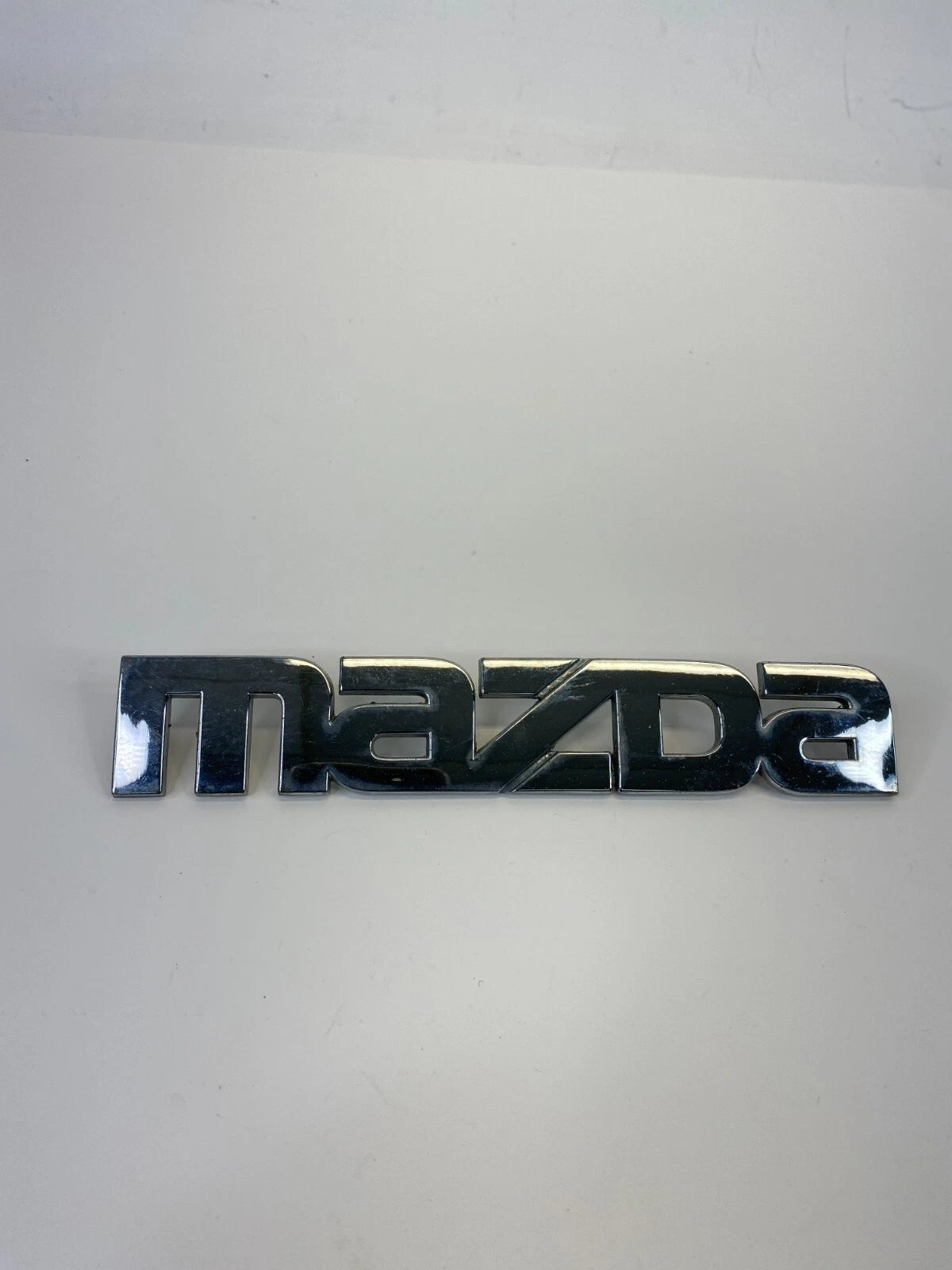 2000-2006 MAZDA MPV REAR TRUNK LID SYMBOL NAMEPLATE BADGE LOGO LC62-51710 OEM