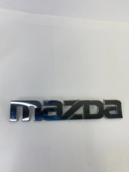 2000-2006 MAZDA MPV REAR TRUNK DECK LID NAME NAMEPLATE BADGE LOGO LC62-51710 OEM