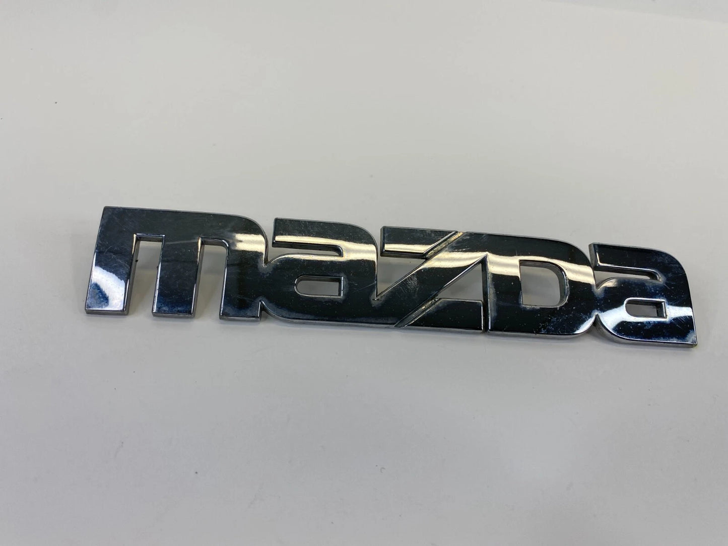 2000-2006 MAZDA MPV REAR TRUNK LID SYMBOL NAMEPLATE BADGE LOGO LC62-51710 OEM