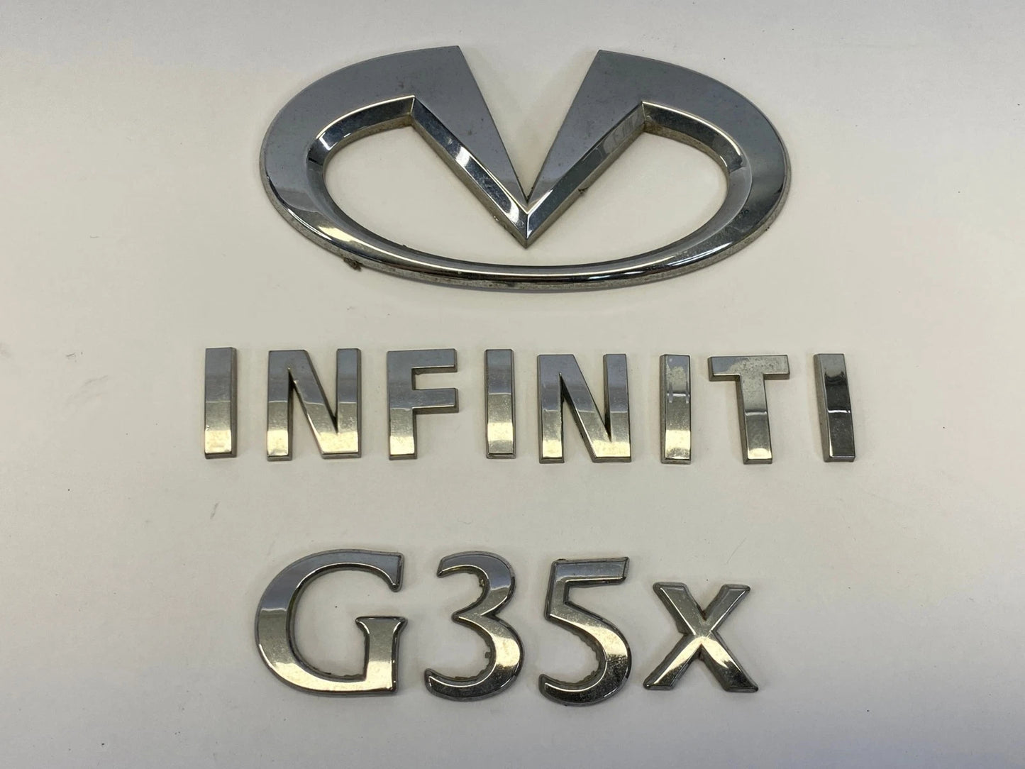 2007 2008 INFINITI G35 REAR TRUNK LID LOGO LETTERS EMBLEM SET OEM 84890JK60